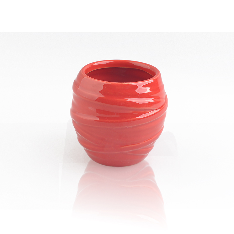 red glazing candle holders with spiral pattern