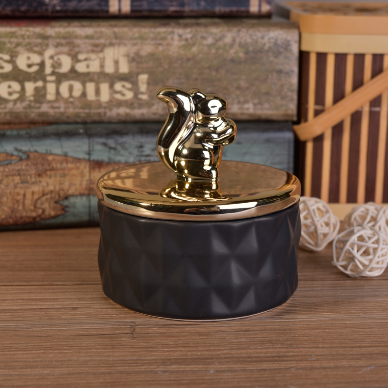 Matte black ceramic containers with gold animal lids Matte black ceramic containers with gold animal lids