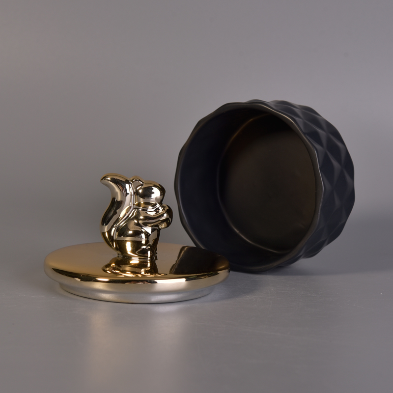 Matte black ceramic containers with gold animal lids Matte black ceramic containers with gold animal lids