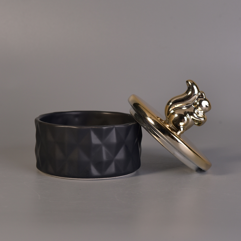 Matte black ceramic containers with gold animal lids Matte black ceramic containers with gold animal lids