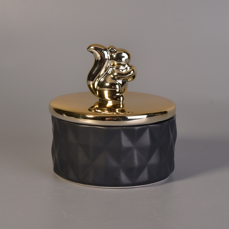 Matte black ceramic containers with gold animal lids Matte black ceramic containers with gold animal lids