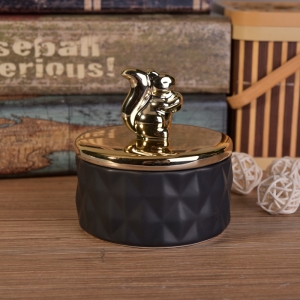 Matte black ceramic containers with gold animal lids
