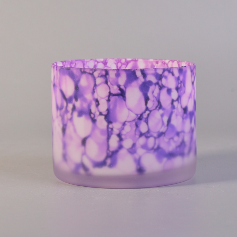 Glass candle holder frosted outside with iridescent color pattern 