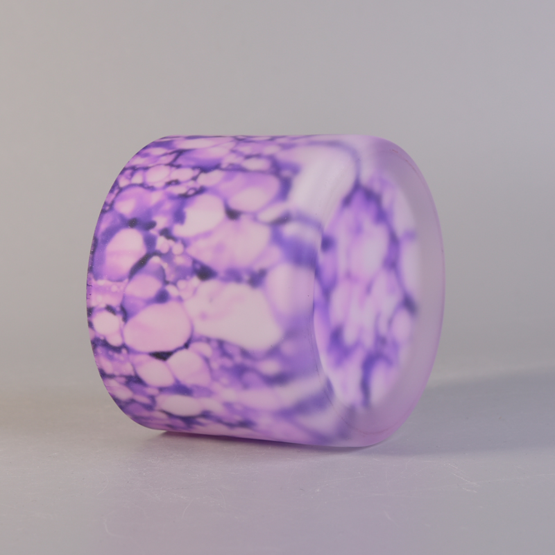 Glass candle holder frosted outside with iridescent color pattern 