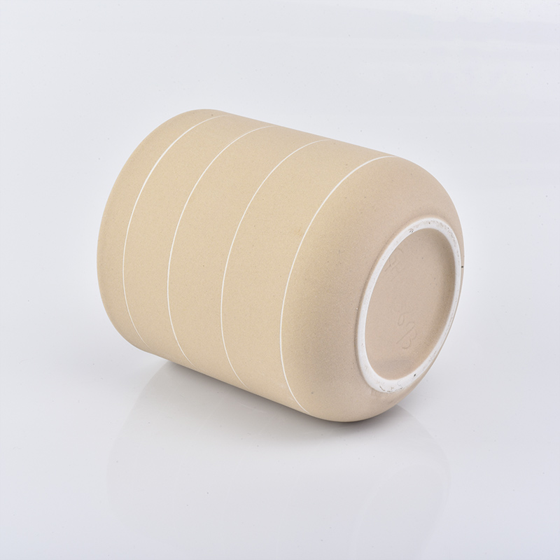 curved bottom matte yellow ceramic candle jar with white lines