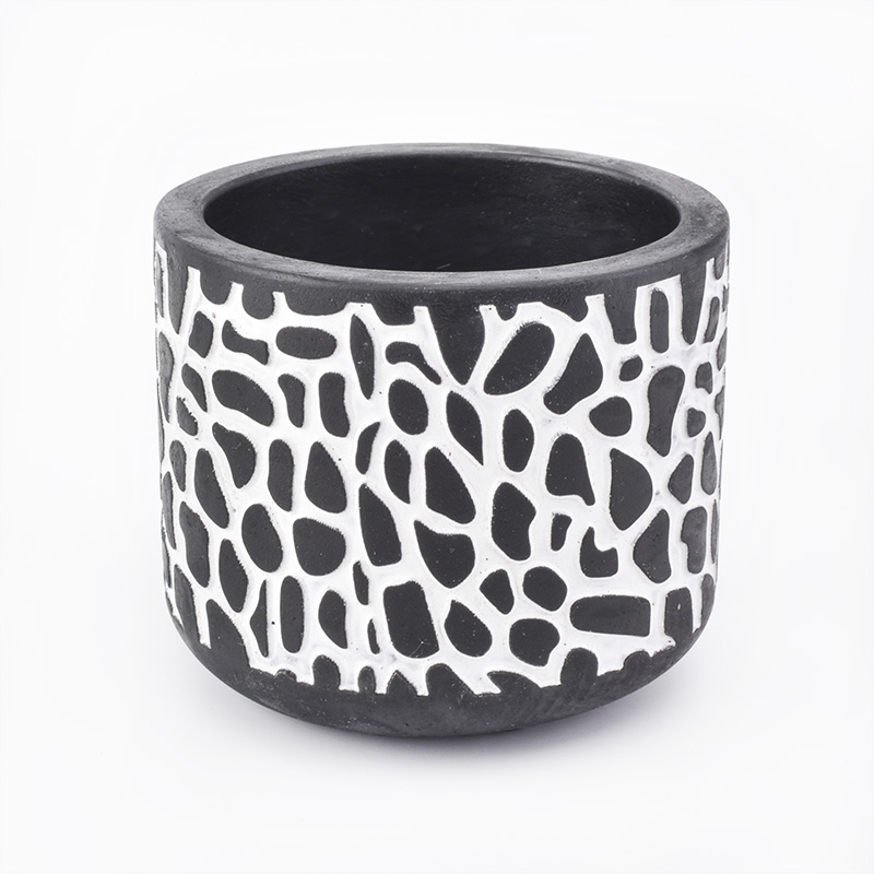 black candle jar with white decorative lines