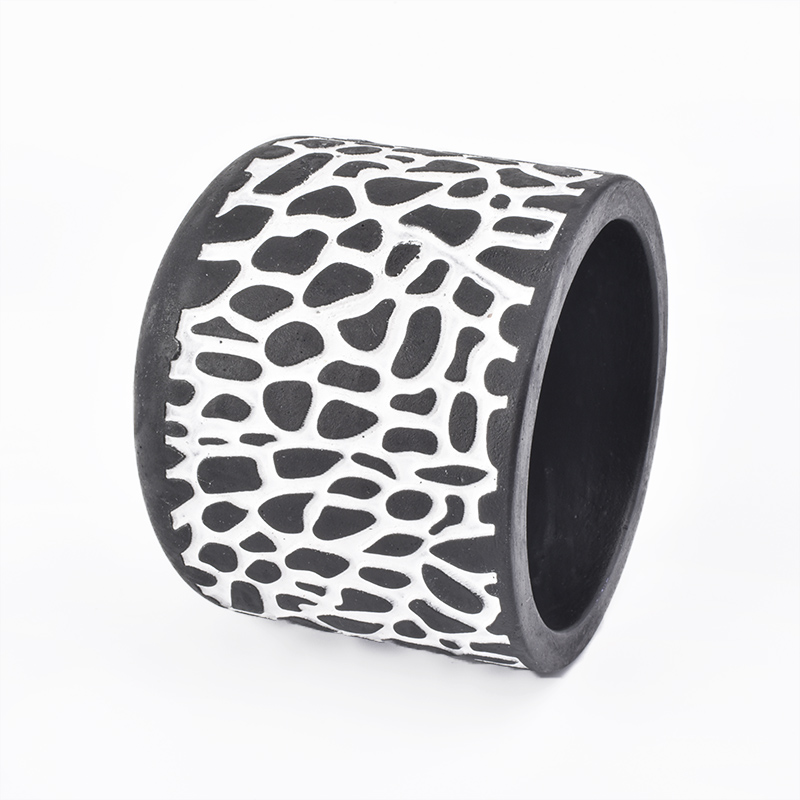 black candle jar with white decorative lines