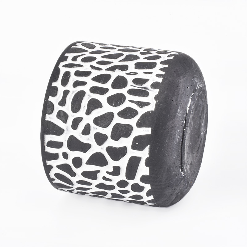black candle jar with white decorative lines