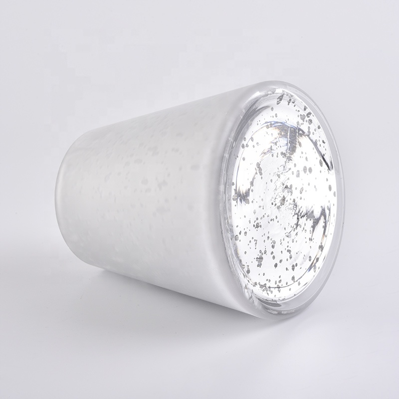 Large white glass candle vessels with mercury decorations