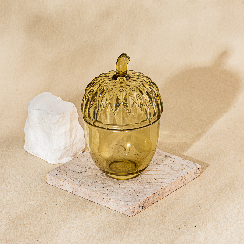 Venta al por mayor de tarros de vela de vidrio con forma de bellota de color ámbar con tapas