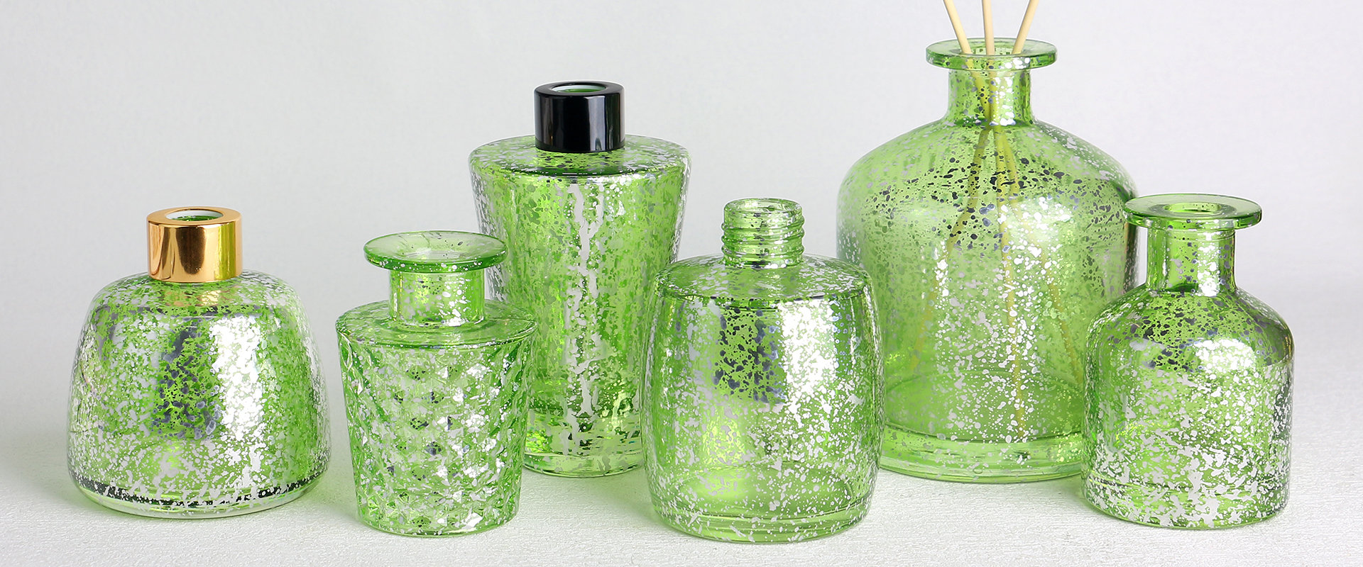 Electroplated laser glass diffuser bottles banner