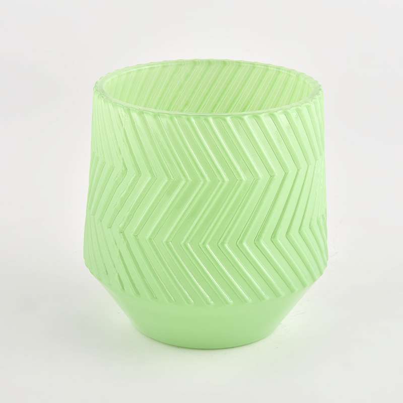 green glass candle holder with embossed pattern