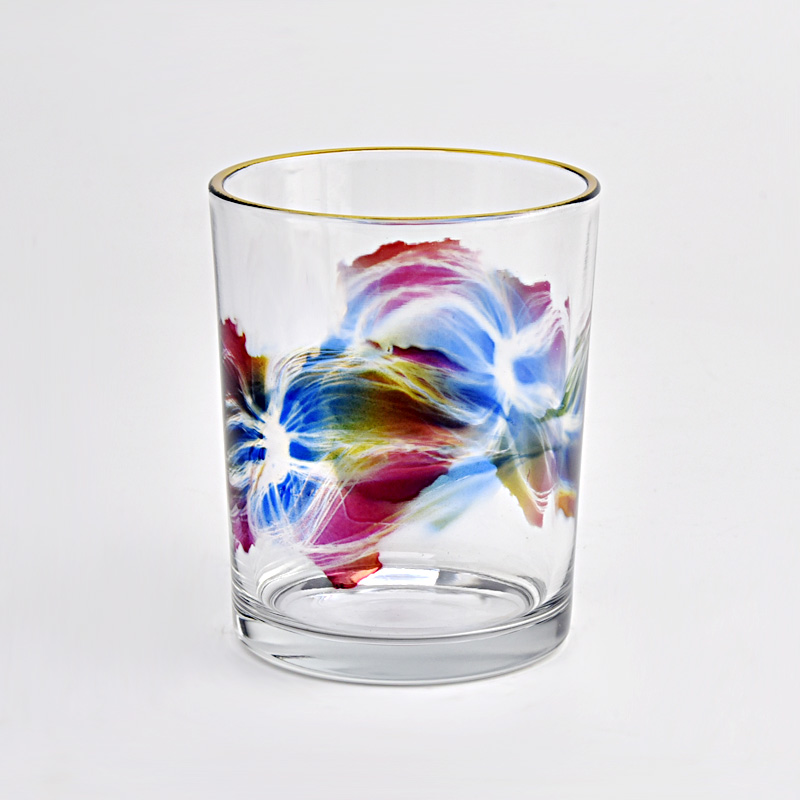 clear glass candle jar with colorful painting and gold ring