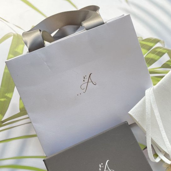 mini white paper bag with gray ribbon handle