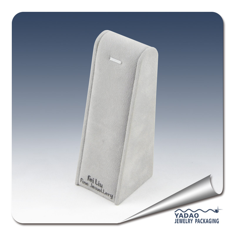 Tvaru trojúhelníku samet vztahuje logem šperky šedý náhrdelník s přívěskem displej stojan