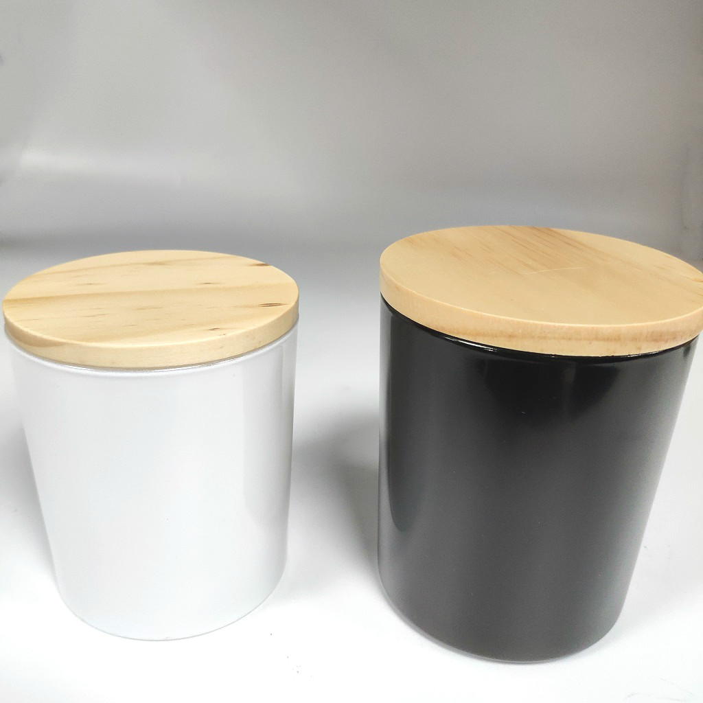 white and black glass candle jars with wood lid