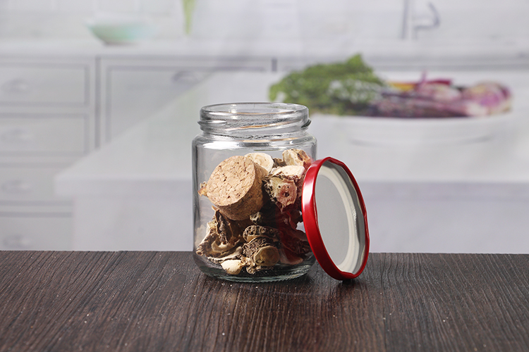 round glass jar with red metal lids